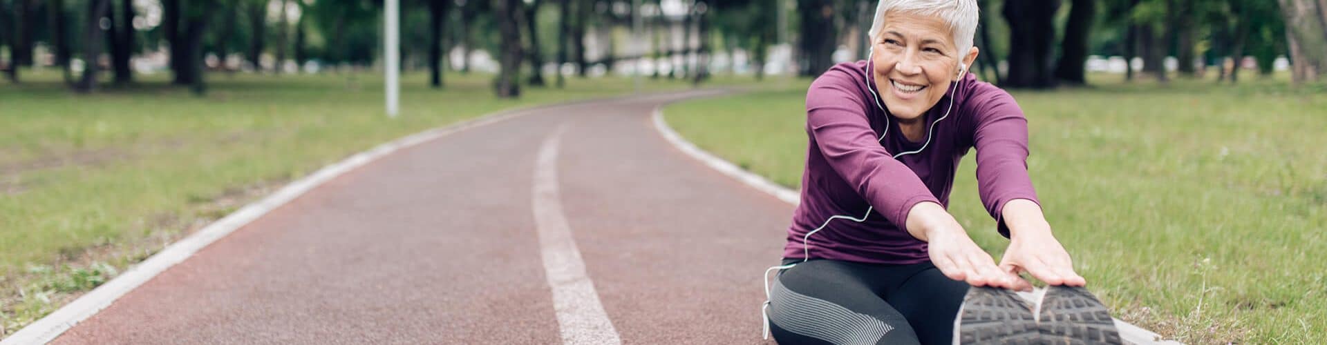 Mulher idosa feliz esticando e se preparando para correr